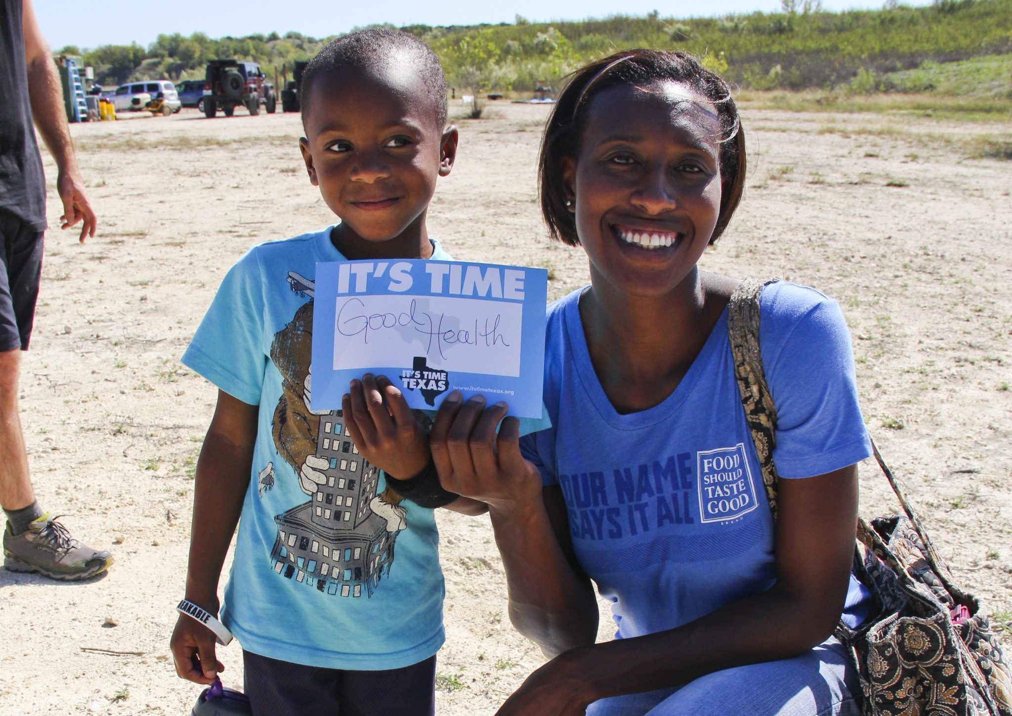 A woman and her child posing for a photo holding a sign that says "It's Time Texas."