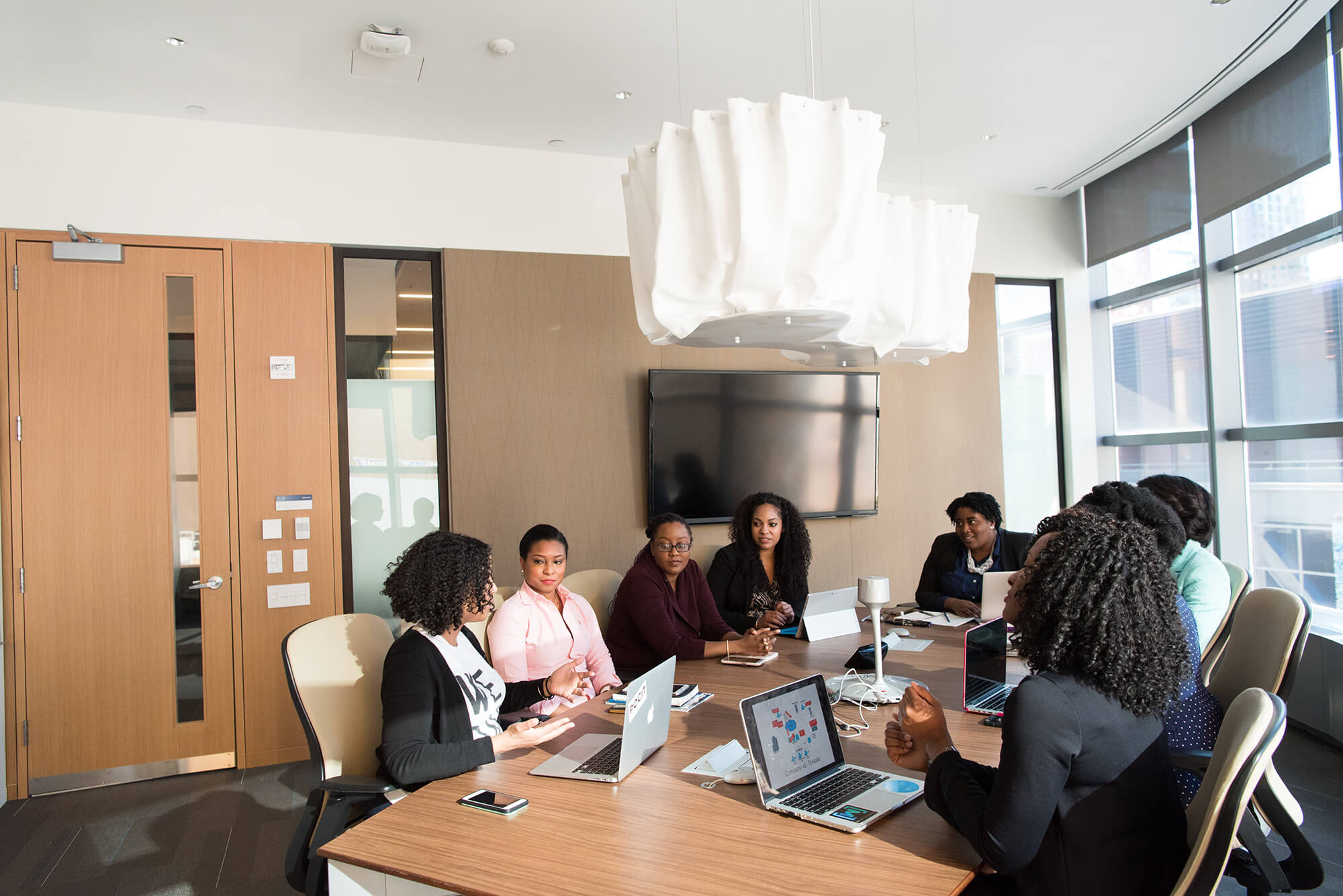 Women of color meeting together in a conference room