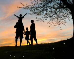 silhouette of a mult-generational family at sunset