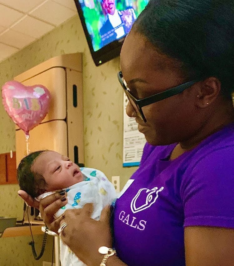 Giving Austin Labor Support representative holding a newborn baby